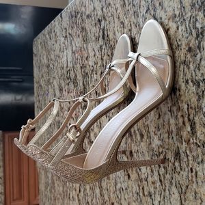 Gold t-strap heel sandal.